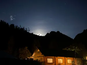 The lodge after dark, under a bright moon