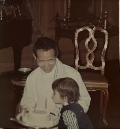 Giap holding the cake he made me for my second birthday