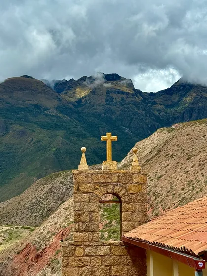 A stone cross against the cloud line