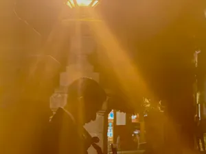 Mariachero beneath a street lamp