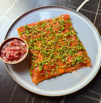 Cured fish, chives, and a bowl of salsa