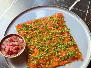Cured fish, chives, and a bowl of salsa