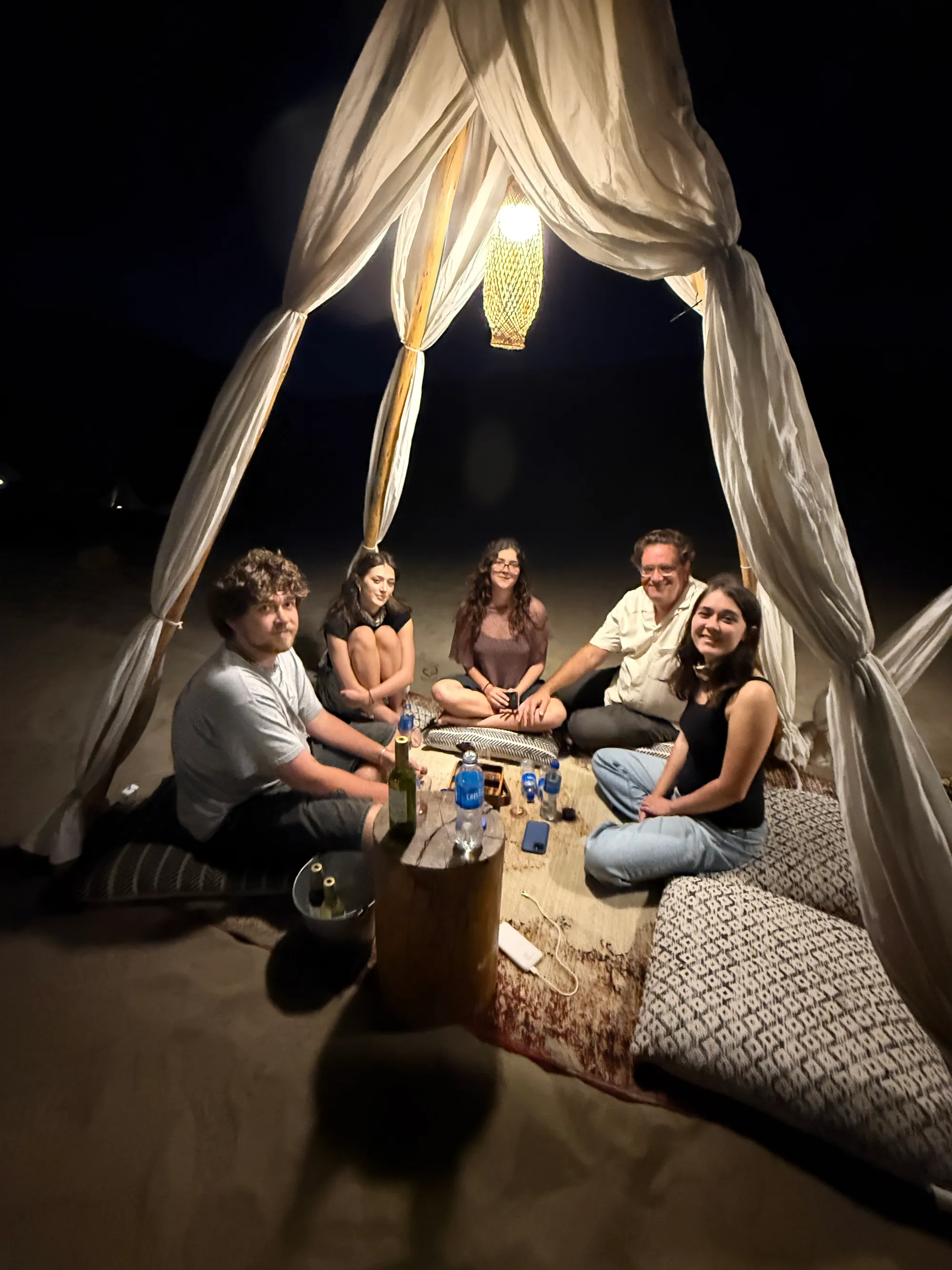 The long table under the canopy, after dark