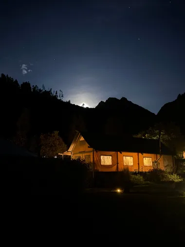 The lodge after dark, under a bright moon